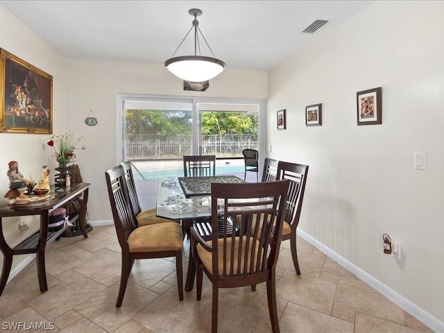 dining room featuring visible vents and baseboards