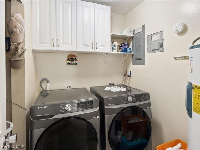 laundry area with water heater, cabinet space, washing machine and dryer, and electric panel