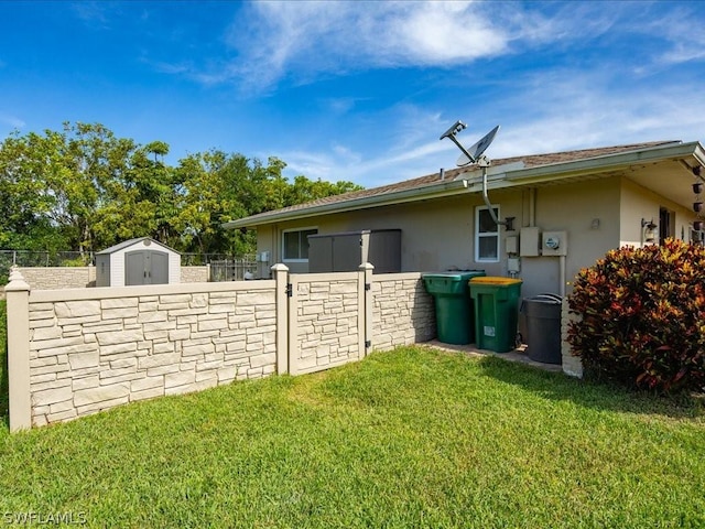 view of property exterior with a shed, fence, an outdoor structure, and stucco siding