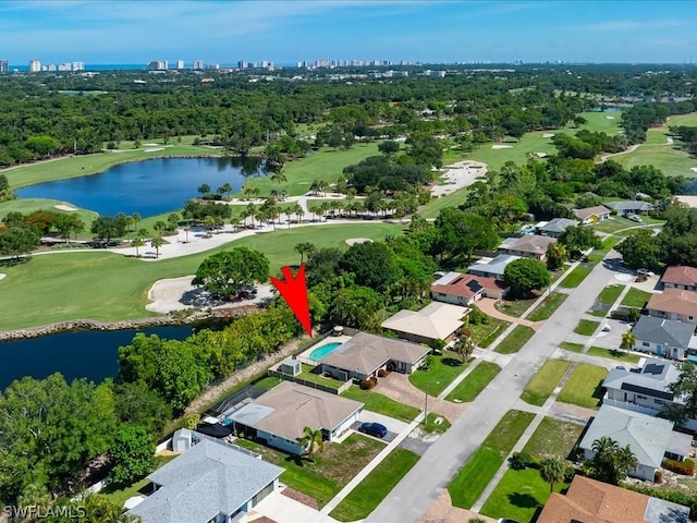 drone / aerial view with a water view and golf course view