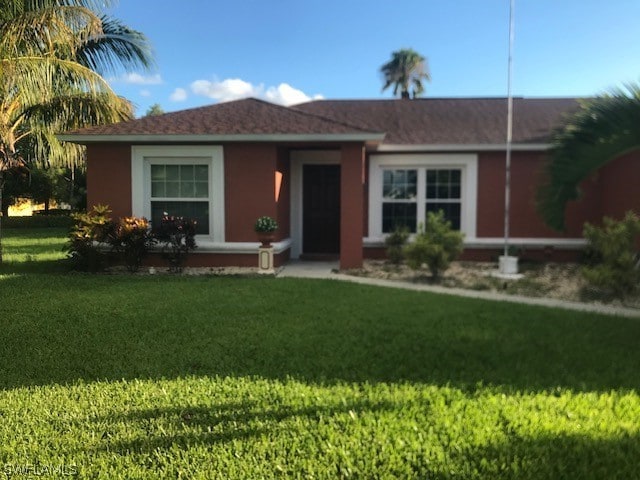 ranch-style home with a front yard