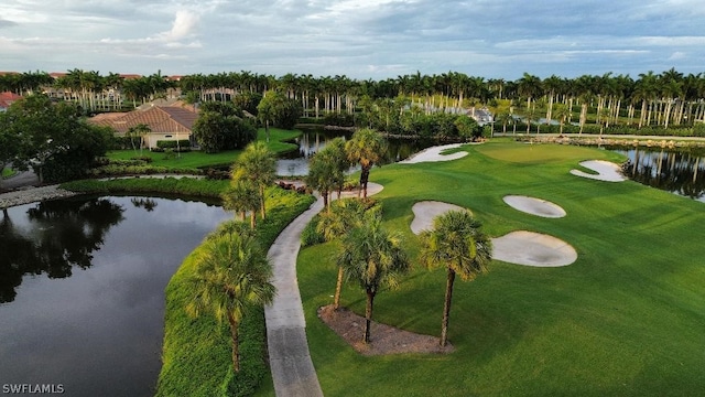 surrounding community featuring a lawn and a water view