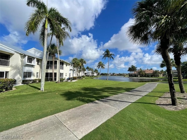 view of property's community featuring a water view and a yard