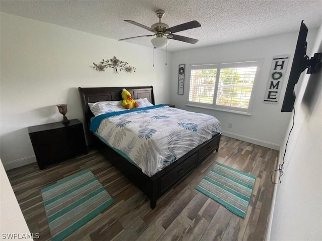 bedroom with dark hardwood / wood-style floors, ceiling fan, and a textured ceiling