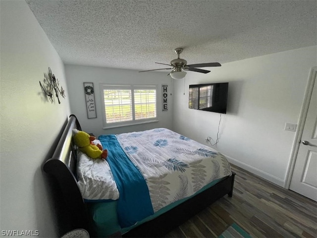 bedroom featuring a textured ceiling, ceiling fan, and dark hardwood / wood-style floors