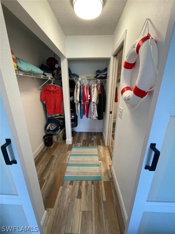 walk in closet featuring hardwood / wood-style floors