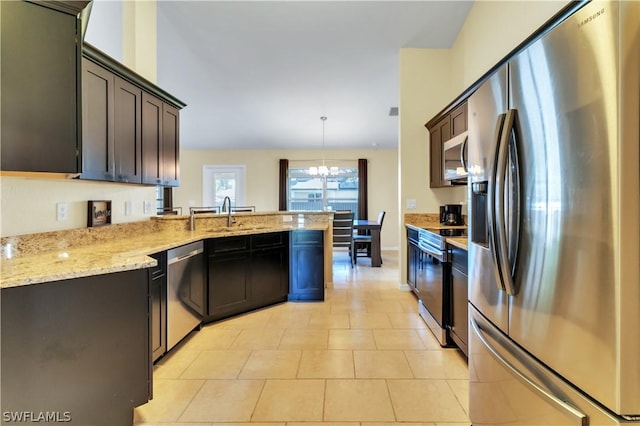 kitchen with dark brown cabinetry, stainless steel appliances, sink, decorative light fixtures, and a notable chandelier