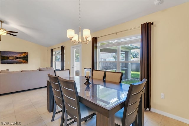 dining space with lofted ceiling, light tile patterned floors, and ceiling fan with notable chandelier