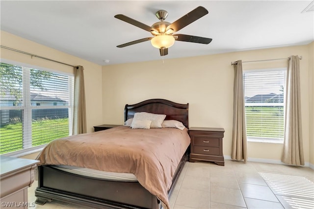 bedroom with light tile patterned floors, multiple windows, and ceiling fan