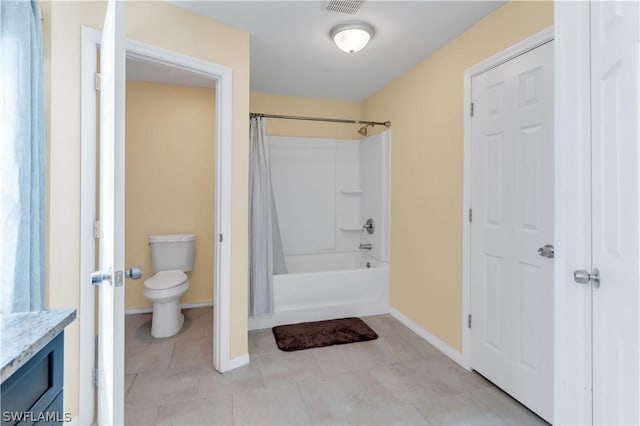 full bathroom featuring vanity, shower / bath combo with shower curtain, tile patterned flooring, and toilet