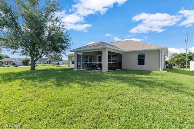 back of property with a lawn, a sunroom, and cooling unit