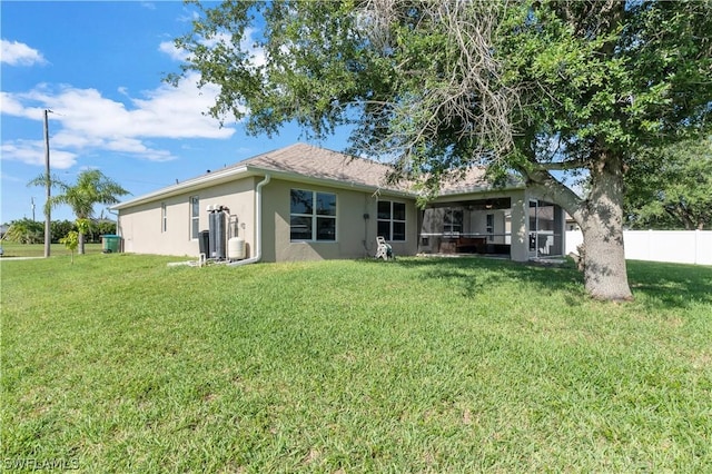 rear view of property with a lawn