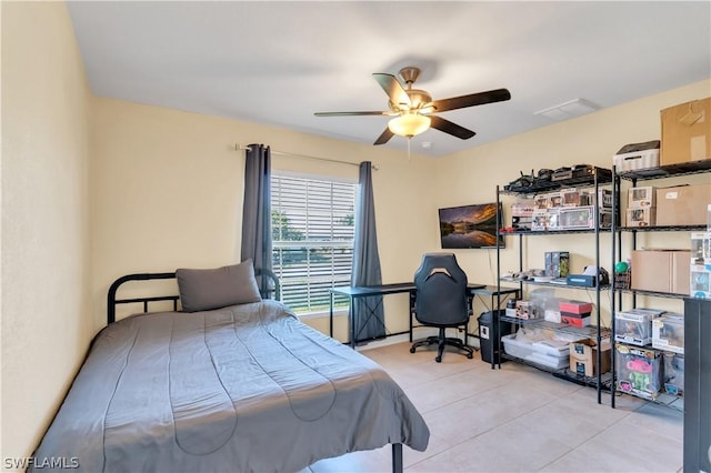 tiled bedroom with ceiling fan