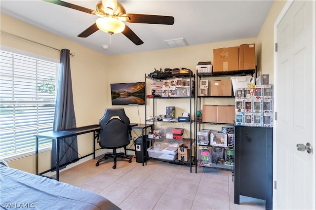 tiled home office featuring ceiling fan