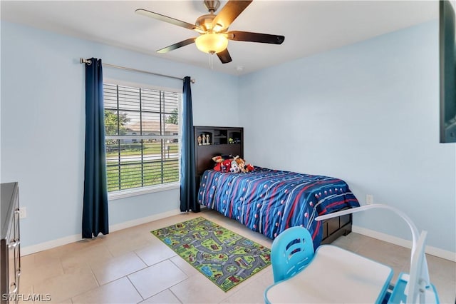 bedroom with ceiling fan and light tile patterned floors