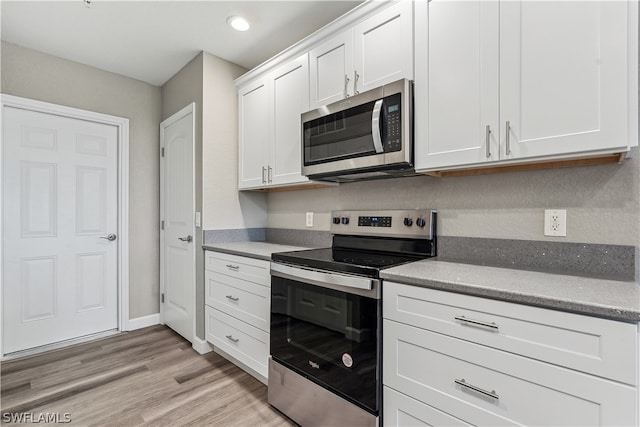 kitchen featuring white cabinetry, stainless steel appliances, and light hardwood / wood-style floors