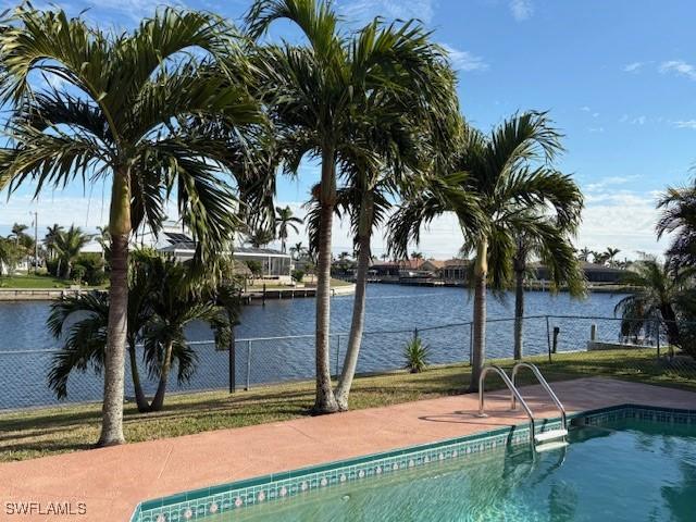 view of swimming pool with a water view