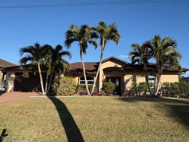 ranch-style home with a garage and a front yard