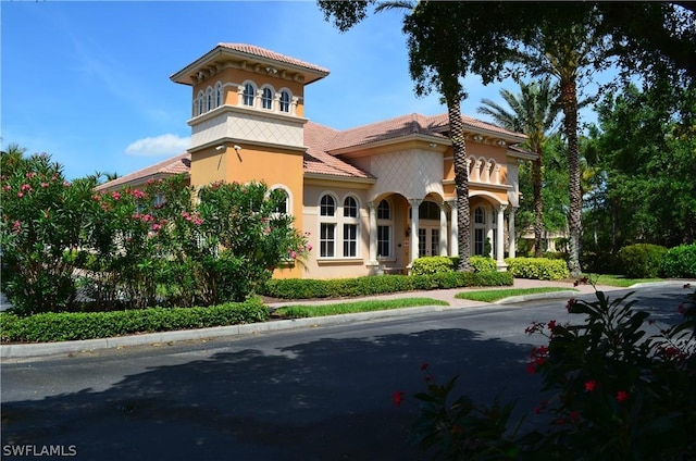 view of front of house with a tiled roof and stucco siding