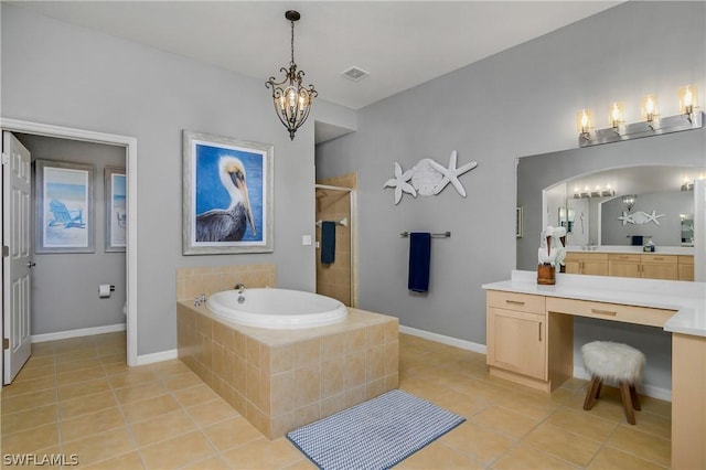 full bath with tile patterned floors, a bath, a stall shower, and a chandelier