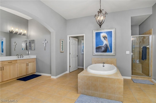 full bath featuring tile patterned floors, a garden tub, a shower stall, baseboards, and vanity