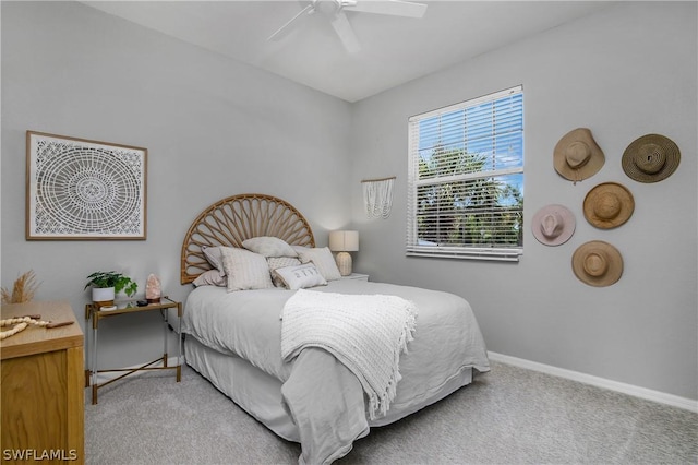 carpeted bedroom with a ceiling fan and baseboards