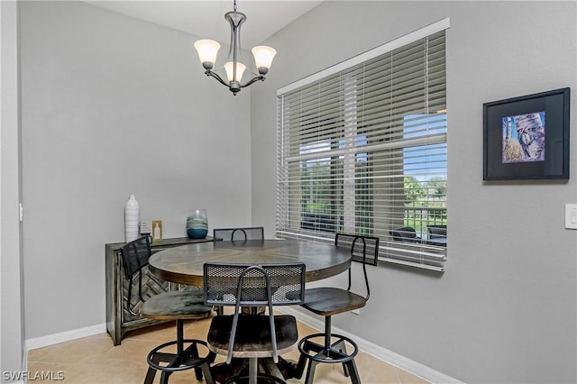 dining space featuring light tile patterned floors and an inviting chandelier