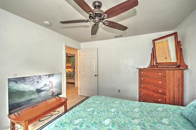 bedroom featuring light wood-type flooring and ceiling fan