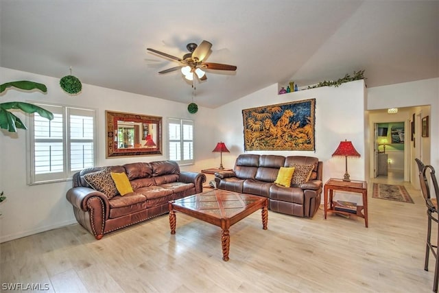 living room featuring lofted ceiling, ceiling fan, and light wood-type flooring