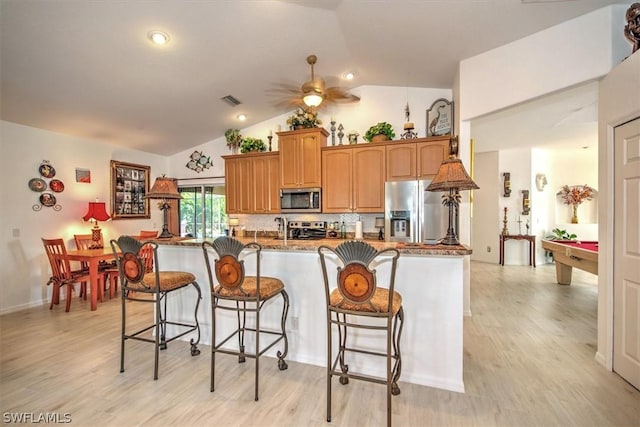 kitchen featuring ceiling fan, tasteful backsplash, billiards, lofted ceiling, and appliances with stainless steel finishes