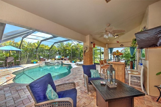 view of pool with an in ground hot tub, glass enclosure, an outdoor bar, and a patio area