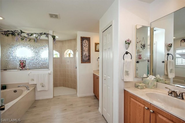 bathroom featuring shower with separate bathtub, vanity, and hardwood / wood-style floors