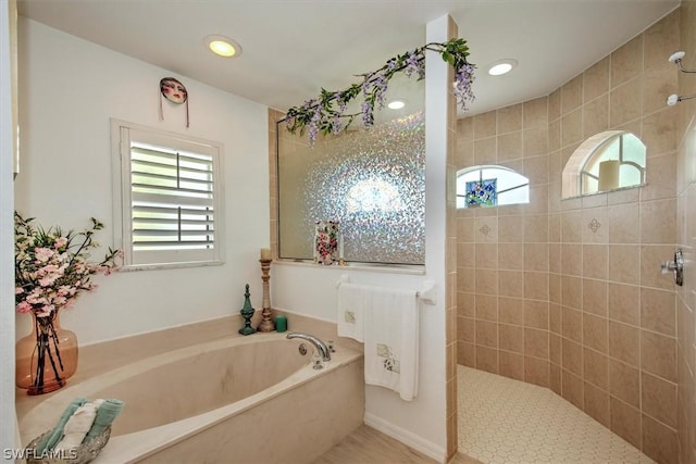 bathroom featuring separate shower and tub