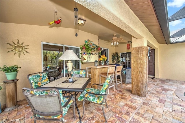 view of patio / terrace featuring ceiling fan and exterior bar