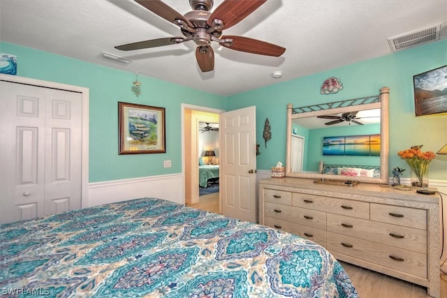 bedroom featuring ceiling fan, light wood-type flooring, and a closet