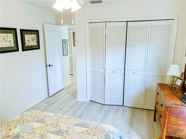 bedroom with a closet and light wood finished floors