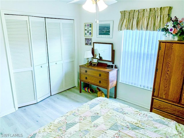 bedroom with a closet, ceiling fan, and light wood finished floors