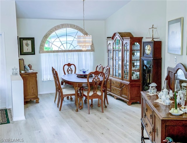 dining space featuring a notable chandelier and light hardwood / wood-style floors