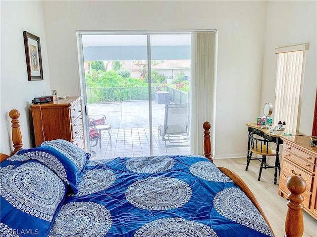 bedroom with light wood-type flooring and access to exterior