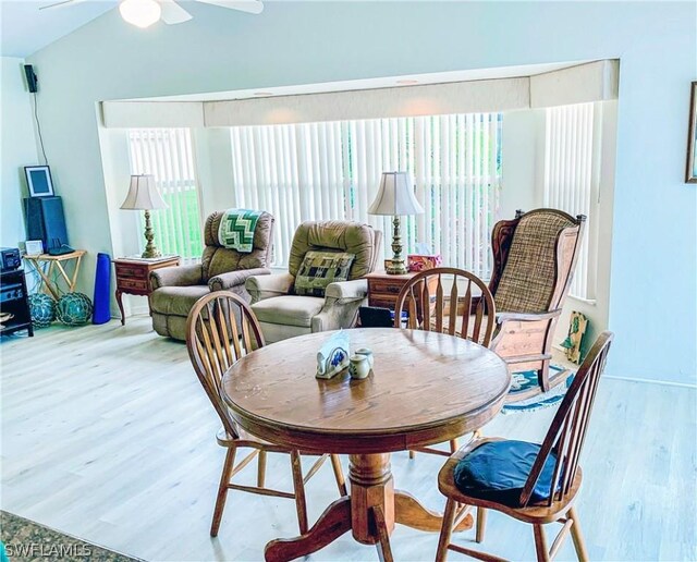 dining area featuring lofted ceiling, wood-type flooring, and ceiling fan