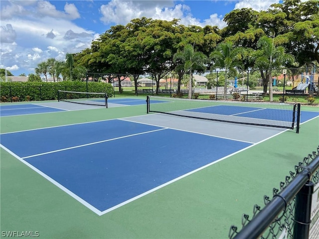 view of tennis court with community basketball court and fence