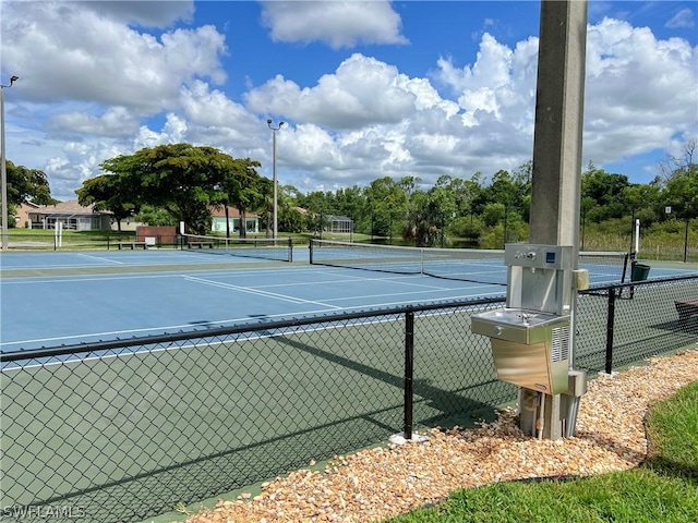 view of sport court featuring fence