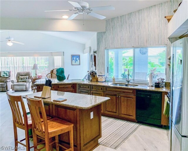 kitchen featuring black dishwasher, sink, ceiling fan, and lofted ceiling