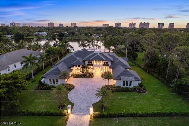 aerial view at dusk with a water view