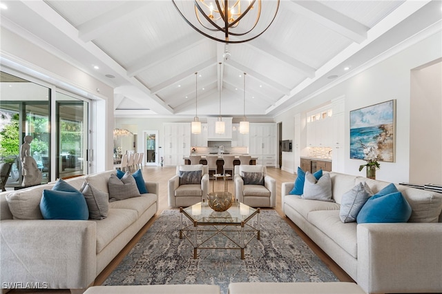 living room featuring vaulted ceiling with beams, hardwood / wood-style floors, and a chandelier