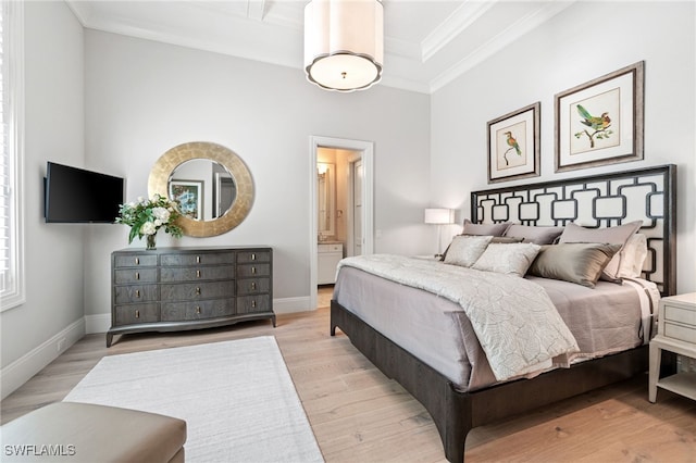 bedroom with ensuite bathroom, ornamental molding, and light wood-type flooring