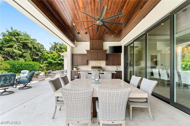 view of patio with an outdoor hangout area, grilling area, and ceiling fan