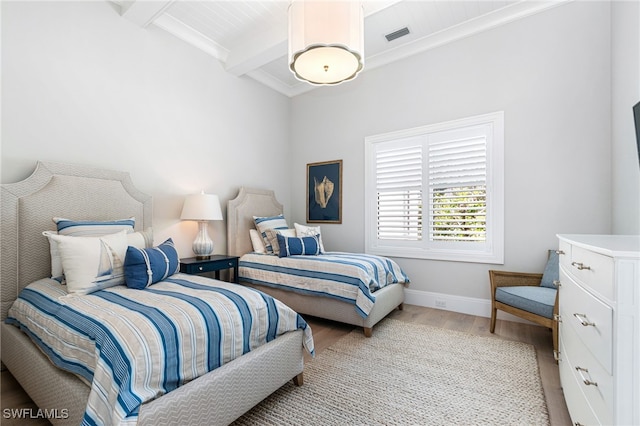 bedroom featuring light hardwood / wood-style flooring, beam ceiling, and wooden ceiling