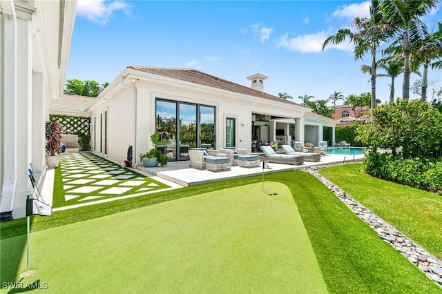 back of property with a patio area and outdoor lounge area