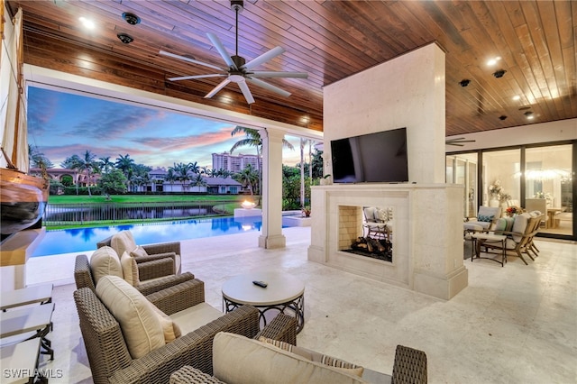 view of patio with a tiled fireplace and ceiling fan